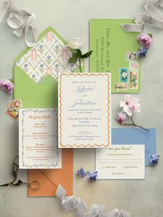 the wedding stationery is laid out on top of each other, including an envelope