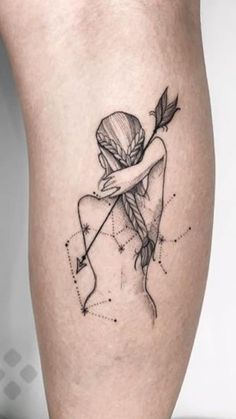 a woman with a bow and arrow tattoo on her leg