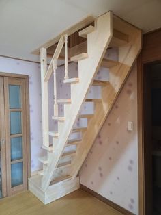 an empty room with a wooden stair case