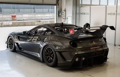 a black sports car parked in a garage