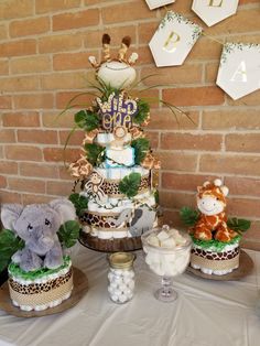 a baby shower cake with giraffes and other decorations