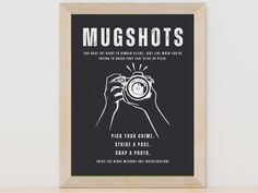 a black and white poster with the words mugshots on it in front of a wooden frame