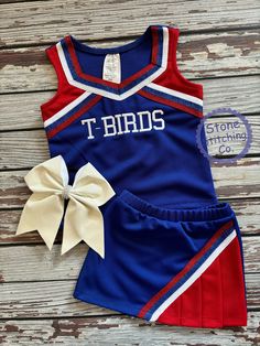 Cute girls cheerleading uniform!  Great for spirit days, pep rallies and sporting events!  This can be customized for your team and is available in multiple color selections.   Set included skirt and shell & mascot embroidered across the front.  BOW IS NOT INCLUDED Sold Separately here: https://www.etsy.com/listing/1709445496/bulldogs-bow-black-gold-bulldogs-bow?click_key=916bd370755ac7b85ceaca90468eb28f98567936%3A1709445496&click_sum=1b5c64d2&ga_search_query=bow&ref=shop_items_search_5&sts=1 Uniform Color: Blue/Red/White Need something custom?  Message me with your requests! Spirit Days, Blue Cheer, Cheerleading Uniforms, Pom Pom Girl, Cheer Uniform, Girls Sports, Pep Rally, Cheer Girl, Cheer Bows