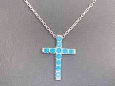 Sterling Silver Turquoise Stone Cross Necklace Easy - Wearing Stylish design   925 sterling silver delicate chain with turquoise stone cross pendant Cross charm slides freely along the length of the chain Ideal for every day wear  Highest quality guaranteed 925 sterling silver (92.5% pure silver)  Specifications:    Color: Silver   & Turquoise Blue Material: 925 sterling silver & Turquoise Stone    Dimensions of cross: 17 mm x 12 mm approximately Length of necklace: 40 cm + 5 cm extension approximately Package Includes: 1 x cross necklace with complimentary jewellery pouch Dainty Blue Sterling Silver Turquoise Necklace, Dainty Blue Turquoise Necklace In Sterling Silver, Sterling Silver Cross Necklace With Gemstone, Aquamarine Necklace Cross, Turquoise Cross Pendant Necklace As Gift, Blue Sterling Silver Cross Necklace Gift, Elegant Turquoise Cross Jewelry, Handmade Silver Cross Turquoise Necklace, Turquoise Cross Pendant Necklace For Gift