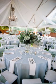 an outdoor wedding reception with blue and white decor