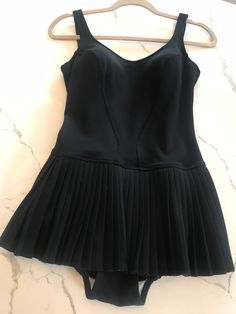 This swimsuit is amazing! Made by Nelbarden of England.. this is a European size 36. This would be a modern small.  Everything looks in great condition. There is a built in  bra, A beautiful accordion skirt attached... A little dropped waist which is very flattering. This brings me right back to the poolside with Frank Sinatra..✨❣️ Please note pictures for any flaws. This is pre-loved and so it is not perfect. This has been laundered and is ready to wear. There seems to be some white flaking on the fabric of the bra on the interior. Very minor. This is a keeper for any vintage affair... Or even a great photo shoot🙌 Fitted Sleeveless Lined Tankini, Fitted One-piece Lined Tankini, Pool Swim Dress Lined, Fitted Lined Swim Dress For Poolside, Fitted Swim Dress For Pool With Lined Body, Fitted Lined Swim Dress For Beachwear, Fitted One-piece Lined Swimwear, Fitted One-piece Swimwear For Evening, Fitted Lined Tankini For Party