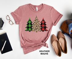 a t - shirt with leopard print trees on it next to shoes and other items