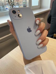 a woman's hand holding an iphone case