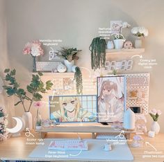 a computer desk with flowers, plants and pictures on the wall above it's keyboard