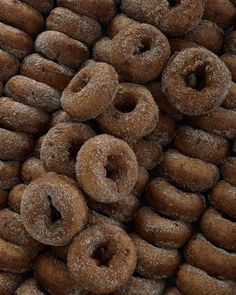 a pile of sugared donuts sitting on top of each other