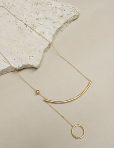 VIGNETTE - Gold Curve Necklaces — L & G Studio Modern Long Necklace Jewelry For Layering, Modern Long Necklace For Layering, Modern Lariat Necklace With Delicate Chain, Modern Yellow Gold Lariat Necklace, Modern Pendant Necklaces For Layering, Modern Pendant Necklace For Layering, Modern Lariat Jewelry For Layering, 20th Century, Gold Jewelry