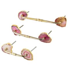 three pairs of pink and gold ear clips with spiral designs on each end, set against a white background