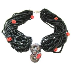 Simply Beautiful Designer Multi Strand Black Onyx and Coral Beads Necklace, suspending a Silver Dragon holding a securely set Coral stone. Seahorse logo on clasp and reverse marked SILVER. Silver tone mountings. Necklace measures approx. 20" in length. Chic and Fabulous…Sure to be admired perfect accessory for the modern woman! Luxury Multi-strand Beaded Jewelry, Black Double Strand Polished Bead Jewelry, Luxury Onyx Jewelry With Black Beads, Elegant Black Beads, Gems, And Cabochons For Gifts, Unique Black Polished Bead Jewelry, Luxury Black Beads Jewelry For Formal Occasions, Unique Black Jewelry With Polished Beads, Luxury Formal Jewelry With Black Beads, Black Polished Bead Pendant Jewelry