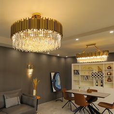 a living room filled with furniture and a chandelier hanging over the top of it