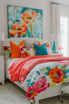 a bed with colorful pillows and blankets on top of it in a bedroom next to a window