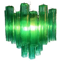 a green glass chandelier hanging from a ceiling