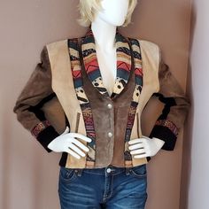 Shell: Genuine Leather. Lining: 100% Acetate Satin. Jacket Is Pieced Together With 3 Colors Of Leather: Taupe, Beige And Black. Trimmed With A Southwestern Style Fabric. Jacket Has Built-In Shoulder Pads And 2 Front Pockets. 2 Silver Colored Snap Closure In Front. Left Bottom Front Has A Small Pin Mark. Right Bottom Front Needs To Be Cleaned. In Overall Great Condition. Chest: 23", Waist: 21", Bottom Width: 22", Sleeve Length: 24", Length From Shoulder To Hem: 22" Mannequin Measures 37" Bust, 29 Bohemian Brown Outerwear For Rodeo, Bohemian Leather Winter Outerwear, Bohemian Leather Outerwear For Winter, Bohemian Fitted Leather Jacket For Winter, Southwestern Style Brown Outerwear For Fall, Southwestern Brown Outerwear For Fall, Bohemian Fitted Leather Jacket For Fall, Southwestern Jacket, Southwestern Necklace