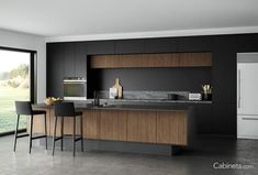 a modern kitchen with black walls and wooden cabinets is pictured in this image, there are two bar stools next to the counter