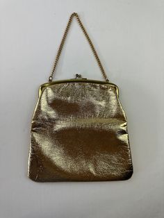 "She fancy - THE DETAILS: Polished shiny metallic gold in color, chain handle, clasp closure, lined ~ Era: 60's ~ Material: man made leather - could be genuine leather but doesn't have tag stating it ~ Condition: Good  - no major flaws, stains on inside, outside is great (see photo) MEASUREMENTS (Flat Lay): ~ Height  8 3/4\" (excludes strap length) ~ Width 9\" ~ Depth 1\"  - Ships quickly - Message with questions - Shop with confidence - No surprises here -  Perfectly imperfect vintage charm may Classic Party Bags With Chain Strap, Leather Shoulder Bag With Gold Chain For Party, Gold Evening Bag With Detachable Strap For Party, Gold Evening Bag For Party With Detachable Strap, Evening Leather Bag With Gold Clasp, Chic Metal Shoulder Bag For Formal Occasions, Leather Evening Bag With Gold Clasp, Gold Metal Bag For Everyday Use, Leather Evening Bag With Chain Strap For Party