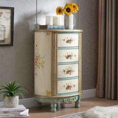 a white dresser with flowers and candles on it in a room next to a window