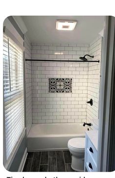 a bathroom with black and white tile on the walls, flooring and shower stall