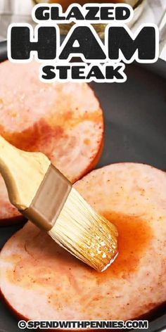 glazed ham steak is being cooked in a skillet