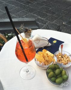 a table topped with plates and bowls filled with different types of food next to drinks