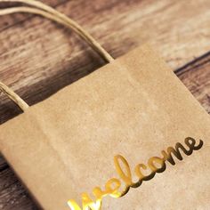 a brown paper bag with the word welcome on it