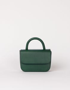 Our ever-popular mini bag, the Nano in a classic autumnal hue: Pine Green, for our FW24 collection. One of the smallest and most compact bags in our collection: The Nano Bag. This itty-bitty bag is all about the essentials. With enough space for your mobile phone, coin purse, lip balm and keys, the little Nano Bag makes a big statement. Featuring an inside zip pocket for extra security and a slip-in pocket for easy access. Her front flap closes with an inner magnet and her strap has a knob-button system to adjust the length. OMB-E137PGV Finnish Fashion, Compact Bag, Weekender Tote Bag, Bags Logo, Pine Green, Boot Bag, Work Bags, Mini Crossbody Bag, Itty Bitty