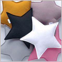 four star shaped pillows in various colors and sizes