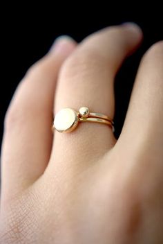 This is a gorgeous ring made of solid 14K Gold. A small, round gold dot sits on top of a stacking ring that we lightly hammer for a bright, reflective band. This listing is for ONE SINGLE ring in solid 14K GOLD. The band measures approx. 1mm thick. This Gold Dot ring stacks perfectly with other rings, and makes a beautiful wedding band or alternative engagement ring! Every piece is organic and unique — no two Hannah Naomi pieces are exactly alike. Hand-crafted to order in our Portland, OR studio Modern Gold Rings Unique, Ring Designs Unique, Unique Gold Wedding Rings, Pebble Ring, Ring Stacks, Alternative Engagement Ring, Dot Ring, Gold Dot, Single Ring