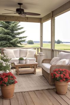 a porch with couches, chairs and potted flowers