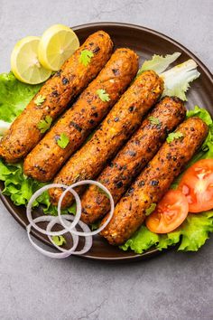 grilled sausages with lettuce, tomatoes and onions on a brown plate