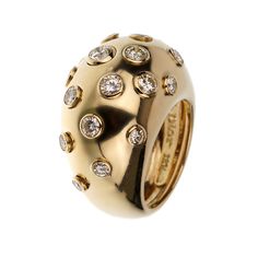 The Christian Dior Vintage Bombe Diamond 18k Yellow Gold Cocktail Ring is an exquisite piece that exemplifies the elegance and luxury synonymous with the Dior brand. This stunning cocktail ring is a perfect blend of classic design and sophisticated glamour, making it a must-have for any jewelry connoisseur. Crafted from 18k yellow gold, this ring features a bold and distinctive bombe design. The bombe style, characterized by its rounded, dome-like shape, creates a striking silhouette that is both eye-catching and timeless. The warm, rich hue of the yellow gold adds a touch of opulence, enhancing the overall allure of the piece. The surface of the ring is adorned with numerous bezel-set diamonds, each meticulously chosen for its brilliance and clarity. These diamonds are strategically place Dior Brand, Victoire De Castellane, Delicate Engagement Ring, Yellow Gold Cocktail Ring, Dior Vintage, Dior Jewelry, Gold Cocktail Ring, Gold Cocktail, Bezel Set Diamond