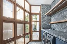 a washer and dryer in a small room with glass doors leading to the outside