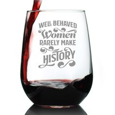 a wine glass filled with red liquid and the words well behaved women rarely make history