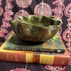 a bowl sitting on top of two books