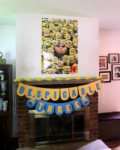 there is a birthday banner on the mantle in the living room with minion decorations