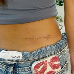 a woman's stomach has a small tattoo that reads, i need ever more