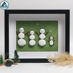 three snowmen are standing next to each other in front of a green background with trees