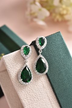 "These green bridal earrings are stunning for bridal occasions whether you want a vintage or classic look. They are made with high quality AAA+ cubic zirconia that glistens on the ear. They come in a sparkling silver finish to give an elegant look. These gorgeous earrings will be carefully wrapped and arrive in a logo gift box. Visit my shop for care instructions and more bridal accessories ➔ https://www.etsy.com/shop/BlushandIvoryStudio Measurements: ► Length: 1.5\" or 3.8 cm ► Width: 0.5\" or Emerald Earrings Real, Emerald Earrings Wedding, Fantasy Accessories, Long Bridal Earrings, Bridal Earrings Studs, Long Chain Earrings, Emerald Green Earrings, Earrings Emerald, True Winter