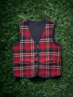 "ALL SALES FINAL. No returns because an item does not fit. Measurements provided are accurate and checked over many times before listing. reach out if you require help determining fit before purchasing. I am happy to help! This vest is one nice layering piece for fall and winter! Gorgeous dark wool plaid in red, black, tan, and green. Looks so good under jackets and even worn alone.  There are no labels and thus came from a guys estate that had a lot of 50's and 60's jackets... so I am placing i Vintage Wool Vest For Fall, Classic Plaid Vest For Fall, Fitted Plaid Vest For Winter, Plaid Vest For Fall, Plaid Sleeveless Vest For Fall, Vintage Wool Sleeveless Sweater Vest, Vintage Sleeveless Wool Sweater Vest, Classic Plaid Vest, Classic Plaid Sleeveless Vest