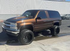 a brown truck parked in front of a building