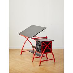 a red and black desk sitting on top of a hard wood floor