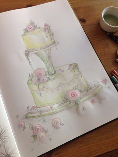 a drawing of a wedding cake with roses on it and a cup of coffee next to it