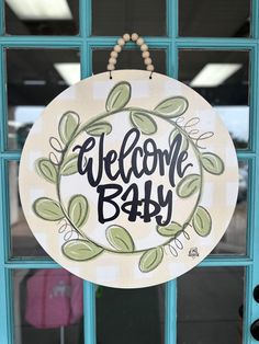 a welcome baby sign hanging on the front door