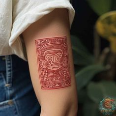 a woman's arm with a red tattoo design on the left side of her arm