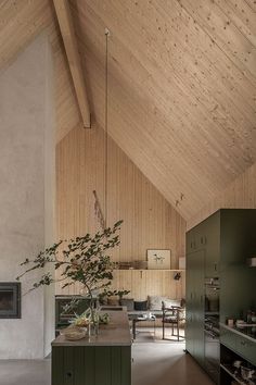 a kitchen and dining area in a house with wooden walls, vaulted ceilings, and floor to ceiling windows