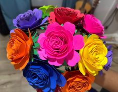 colorful paper flowers are arranged in a bouquet