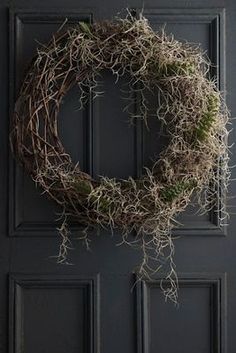 a wreath is hanging on the front door